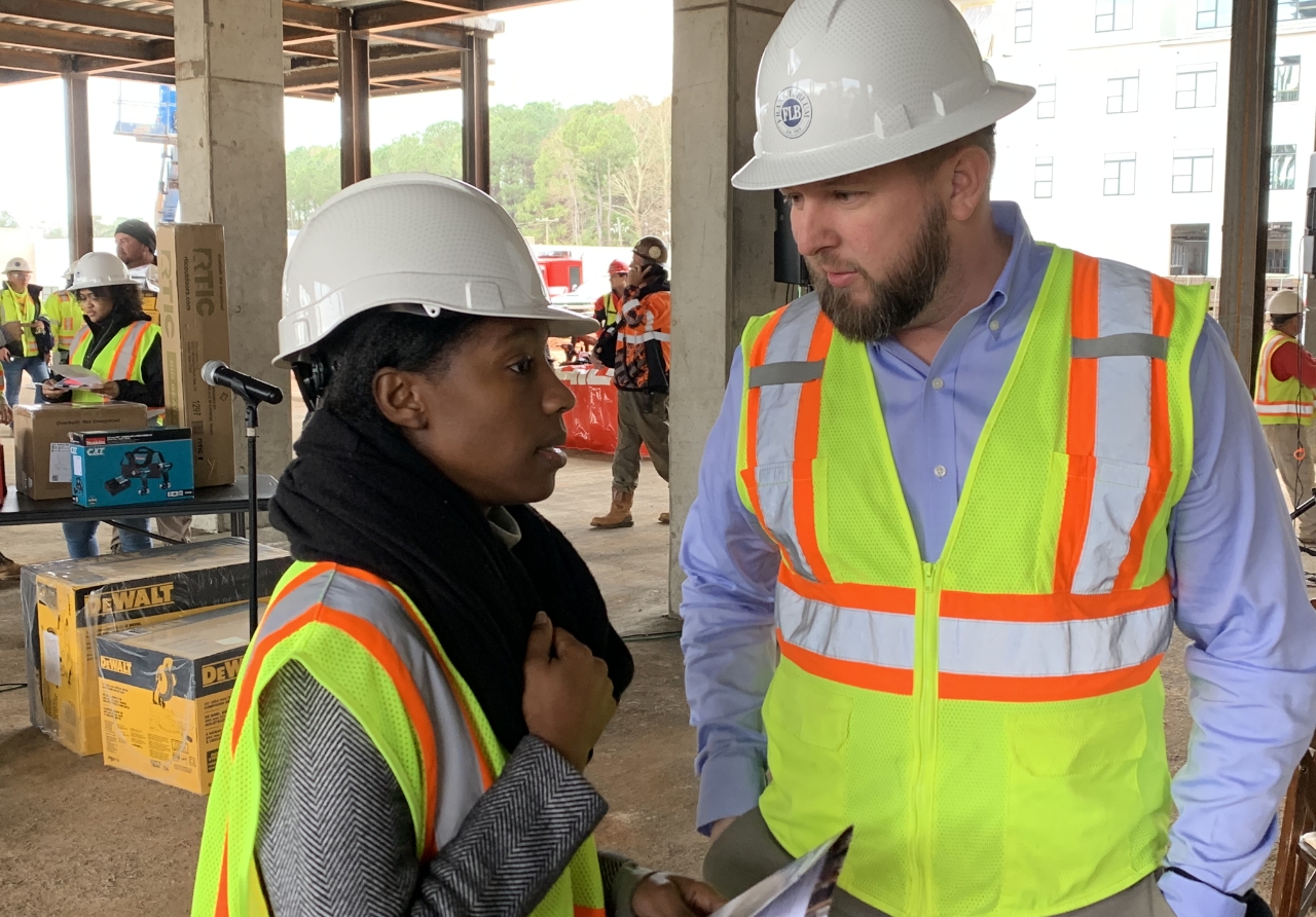 Two Blum employees discussing plans at a work site