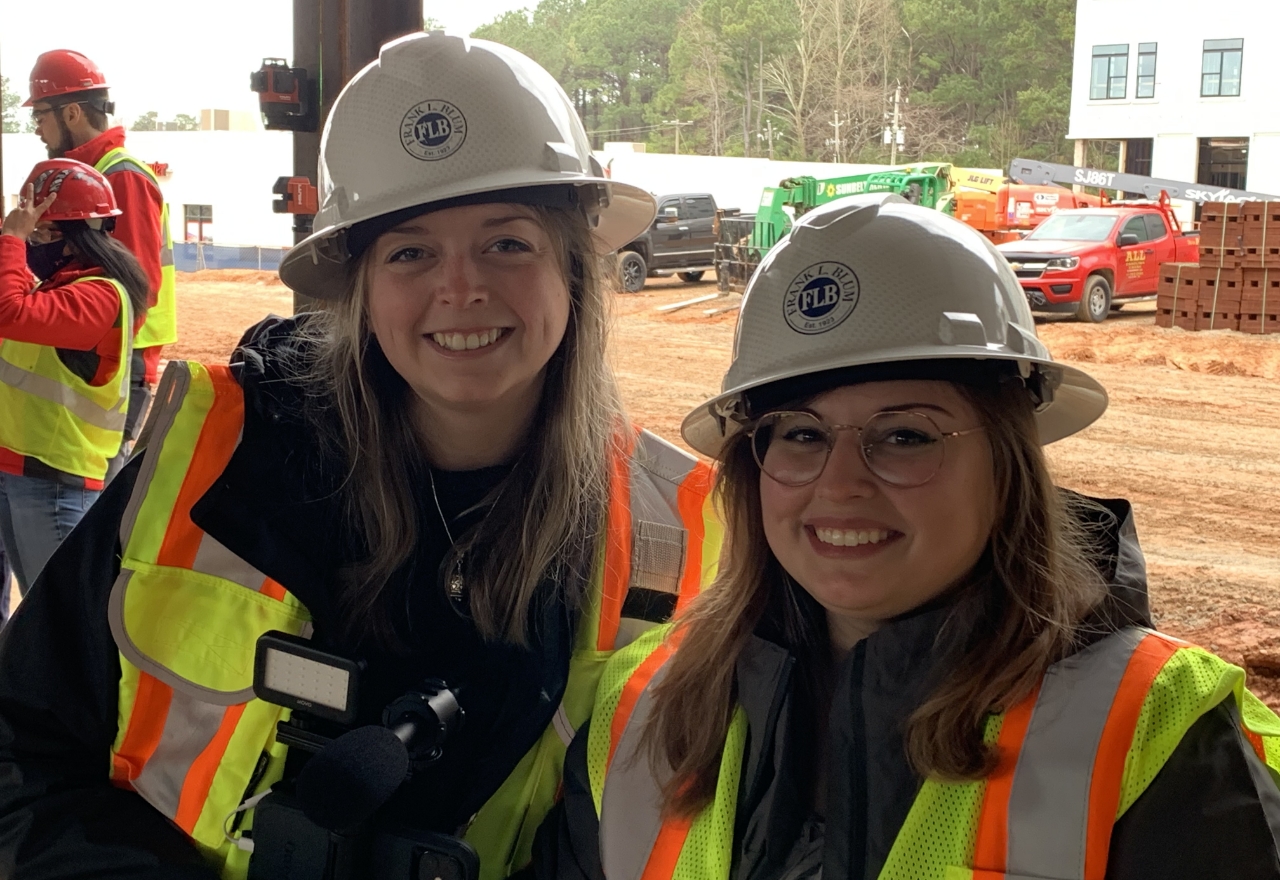 Two Blum employees smiling at work site