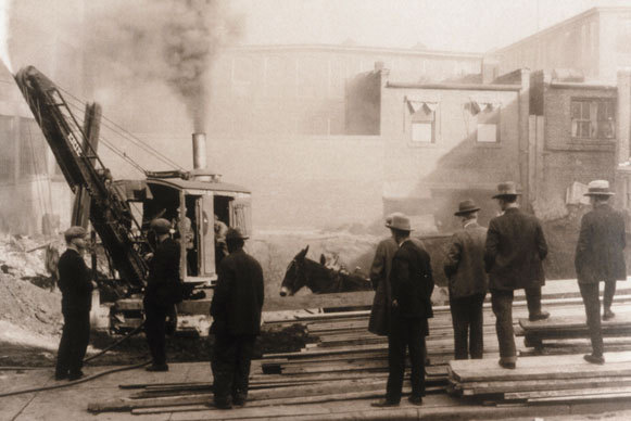 Old black and white photo of a crane being used by Blum workers
