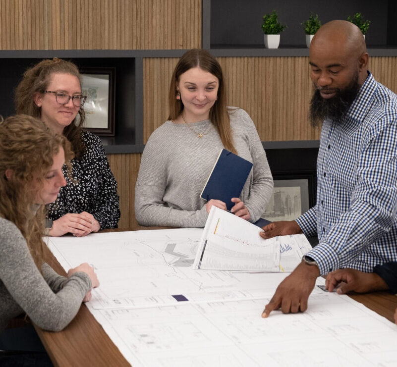 Blum Construction planners looking at blueprints in office