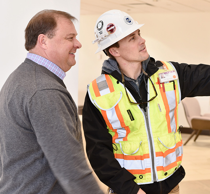 Blum Construction employee showing project to management