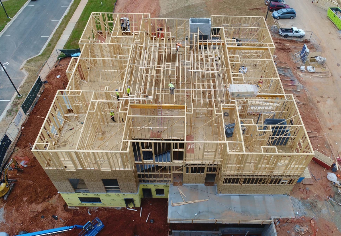 Blum Construction drone view of the wooden frame out of a building in process