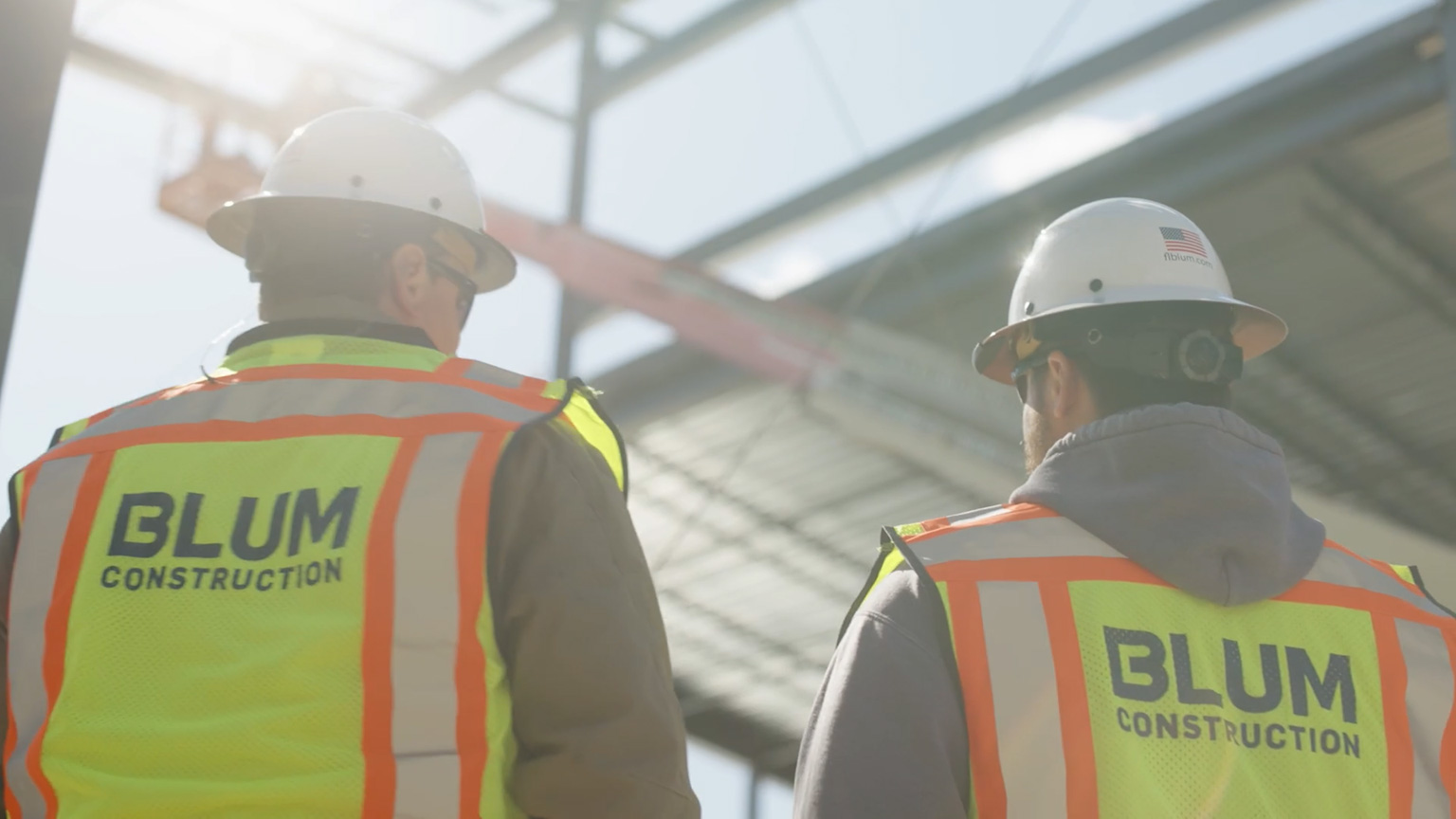 Two Blum workers overseeing a project in the background